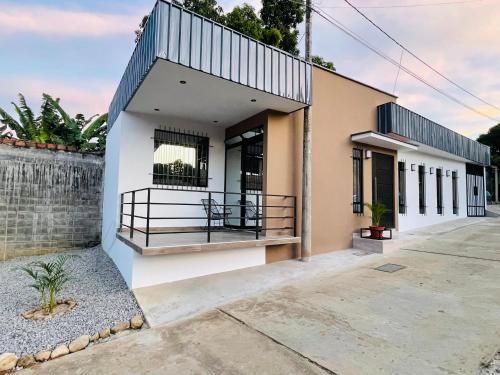 a house with a balcony on the side of it at Casa La Merced in Tarapoto