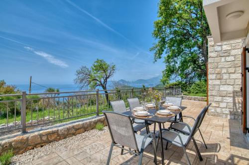 a table and chairs on a patio with a view of the ocean at Seaview Villa Lavanda with pool in Budva