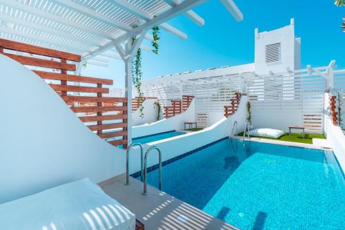 a swimming pool in the middle of a house at Aloe Hotel - Adults Only in Faliraki