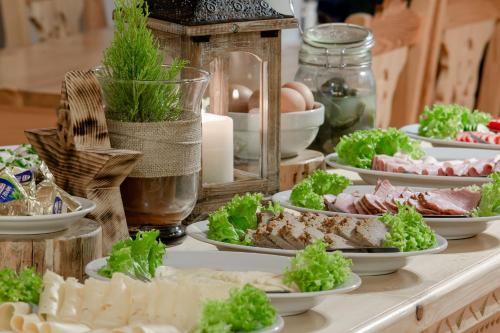 a buffet with plates of food on a table at Góralski Gościniec & SPA in Poronin