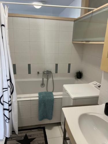 ein Badezimmer mit einer weißen Badewanne und einem Waschbecken in der Unterkunft Apartmán Dolné Bašty in Trnava