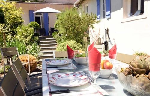 a table with plates and bowls of fruit on it at Gîte chez Madeleine in Louhans