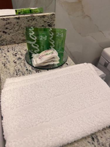 a pile of white towels on a counter in a bathroom at Pousada Mangaba in Barreirinhas