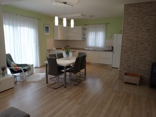 a kitchen and dining room with a table and chairs at Apartman Marija in Grude