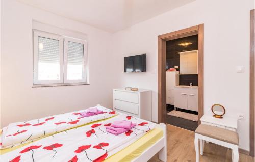 um quarto com duas camas com flores vermelhas em Lovely Home In Pula With Wifi em Pula