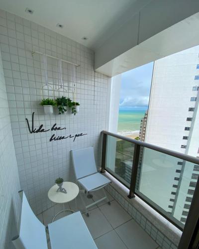 a bathroom with a toilet and a view of the ocean at VISTA MAR BOA VIAGEM - BEACH CLASS EXECUTIVE in Recife