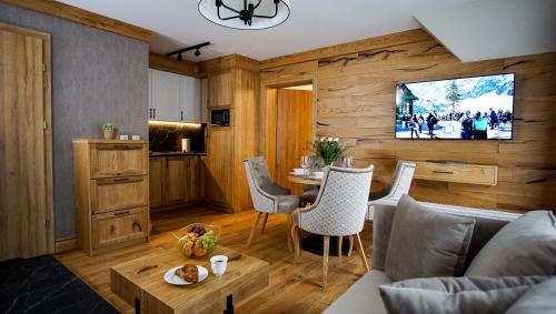a living room with a couch and a table at Aparthotel Merynos in Zakopane