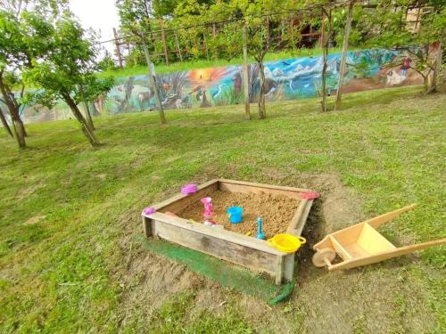 a sandbox in a field with a toy sandbox at Mini hiška v objemu vinograda in Pristava pri Mestinju
