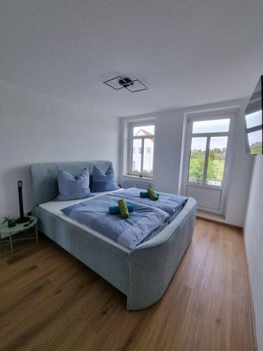 a bedroom with a bed with two stuffed animals on it at Gemütliche Wohnung bei Leipzig in Schkeuditz