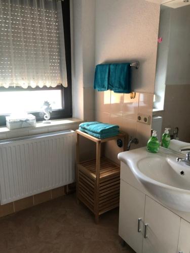 La salle de bains est pourvue d'un lavabo, d'une baignoire et d'une fenêtre. dans l'établissement Ferienwohnung Irma, à Malschwitz