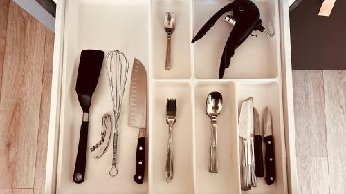 a white tray with utensils on a table at Lost inn Lyon Part dieu -Entre centre ville et gare part dieu -Netflix in Lyon