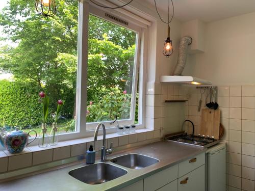 a kitchen with a sink and a window at Loveland in Bergen