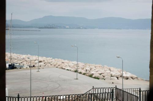 a large parking lot next to a large body of water at Deppy's Two-storey House in Corfu