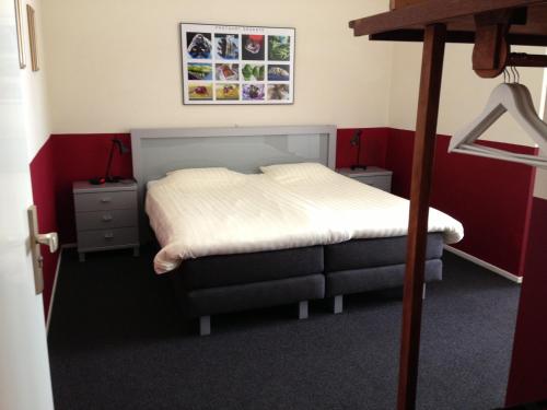 - une chambre avec un lit doté d'un couvre-lit blanc dans l'établissement Auberge aan het Hof, à Blokzijl