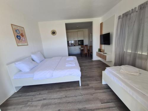 a hotel room with two beds and a kitchen at Vizura in Trebinje