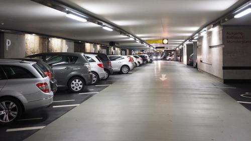 a parking garage filled with lots of parked cars at Hotel Nodo - El hotel que respira in Santiago