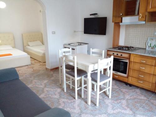 a kitchen with a table and chairs in a room at Villa Arli&Eris in Vlorë