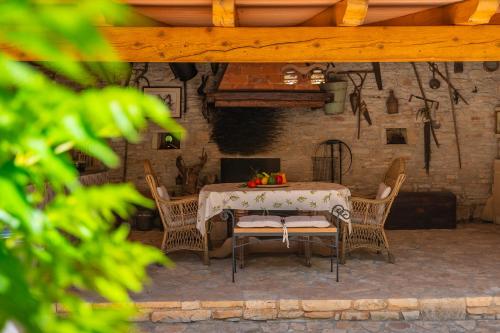 a table and chairs on a patio with a fireplace at Holiday Home Eufemia in Svetvinčenat