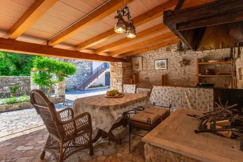 a patio with a table and chairs and a kitchen at Holiday Home Eufemia in Svetvinčenat