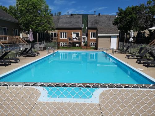 a swimming pool with a fence around it at Condo En Quatre Temps in Beaupré