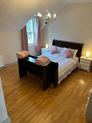 a bedroom with a large bed with a desk at clover cottage in Kinsale