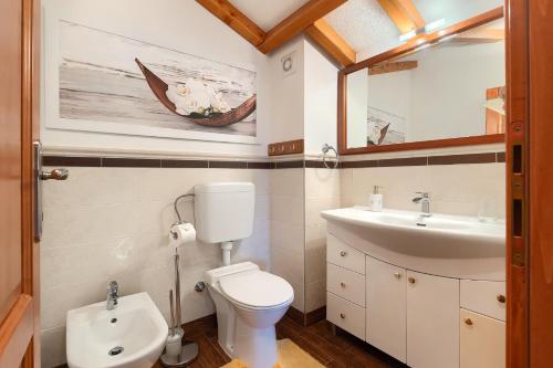 a bathroom with a toilet and a sink at Holiday Home Eufemia in Svetvinčenat