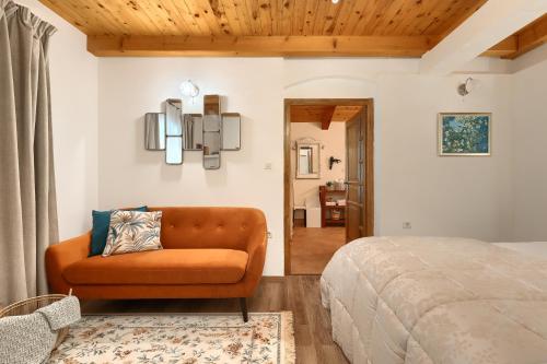 a bedroom with a couch and a bed at Holiday Home Eufemia in Svetvinčenat