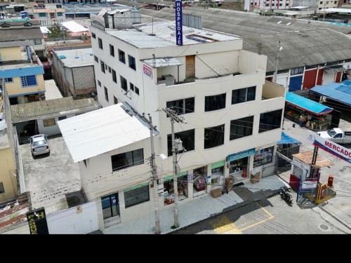 an overhead view of a white building in a city at Hostal Buenaventura Ibarra in Ibarra