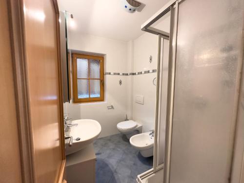 y baño con 2 aseos, lavamanos y ducha. en Posthof, en Campo di Trens