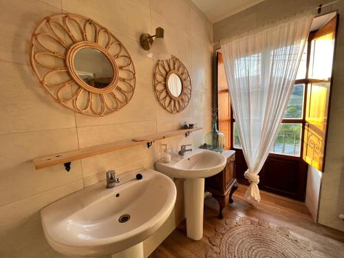 a bathroom with a sink and a mirror on the wall at Maistraren Etxea EVI00179 in Saracho