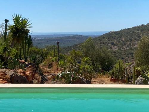 a swimming pool with a view of a mountain at Eco-Villa Monte Do Barrocalinho in Loulé