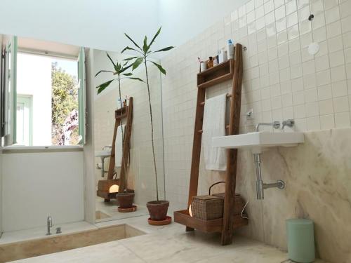 a bathroom with a sink and a tree in it at Eco-Villa Monte Do Barrocalinho in Loulé