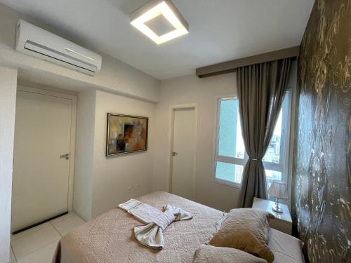 a bedroom with a bed with two towels on it at Lazer nas Alturas in Vila Velha