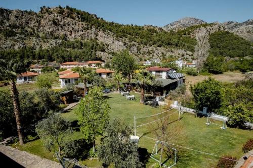 an aerial view of a house with mountains in the background at Bybassios Hotel in Orhaniye