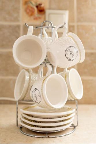 a rack of cups and plates on a stack of plates at Remvi house. Sea and mountains view. in Goúdhouros