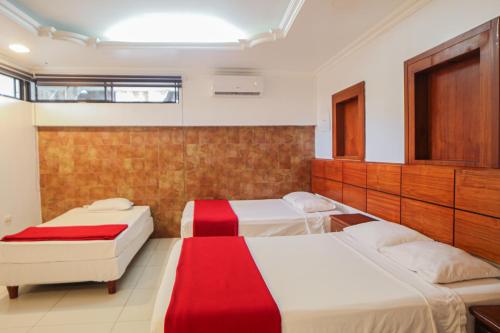 Postel nebo postele na pokoji v ubytování Hotel Murali - Cerca del Aeropuerto de Guayaquil