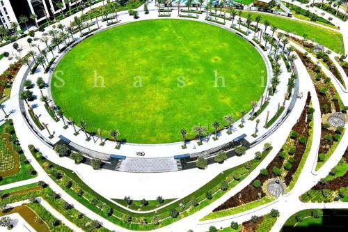 an aerial view of a park with a green field at The Shrashi Suites, Dubai Creek Harbour - Paradise on the Island with Dubai Skyline & Burj Khaleefa View in Dubai