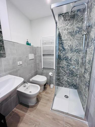 a bathroom with a shower and a toilet and a sink at A Pisa con amore in Pisa