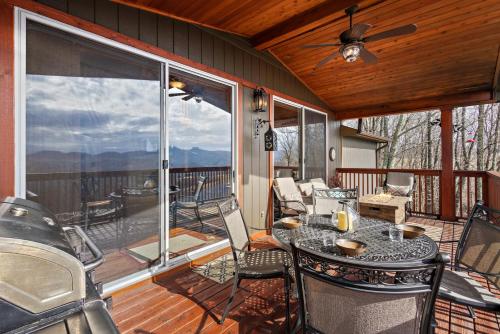 a screened in porch with a table and chairs at Grey Fox in Banner Elk