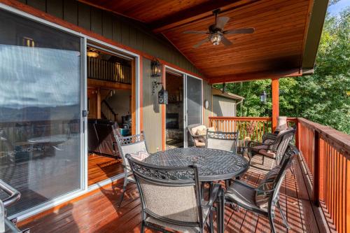 a patio with a table and chairs on a deck at Grey Fox in Banner Elk