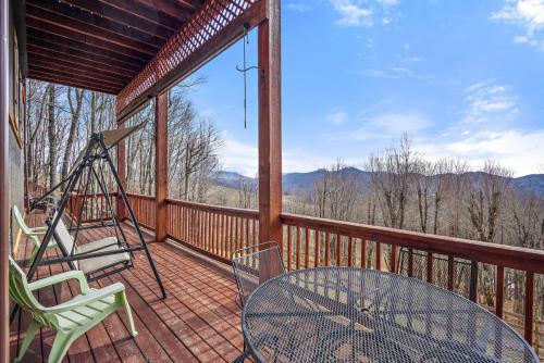 a screened porch with a table and chairs on it at Grey Fox in Banner Elk