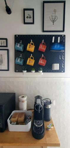 a kitchen counter with a coffee maker on a table at la Dimora del Borgo in Fiumicino