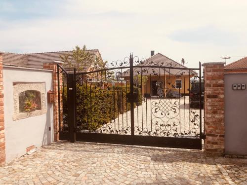a black gate in front of a house at Altes Gewölbe mit Sauna und Whirlpool im Außenbereich in Elsterheide