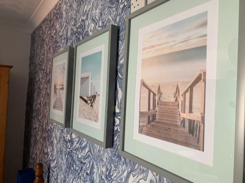 a pair of framed pictures hanging on a wall at Bella Vista in Paignton