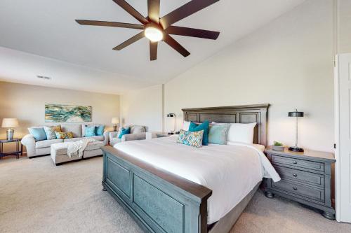 a bedroom with a large bed with a ceiling fan at Lemmon Vista in Oro Valley