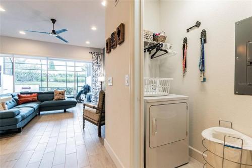 a living room with a couch and a refrigerator at Pool Home Champions Gate Area with Resort Amenities Next to Disney in Davenport