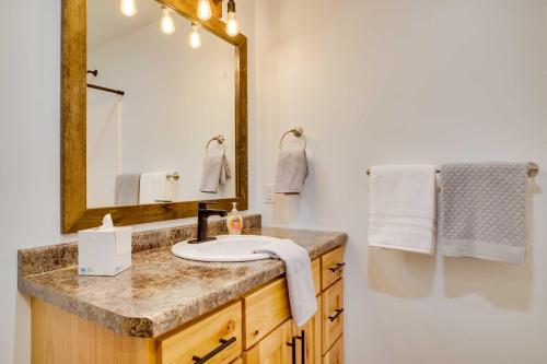 a bathroom with a sink and a mirror at Vacation Rental Cabin Near Lake Arbutus! in Hatfield