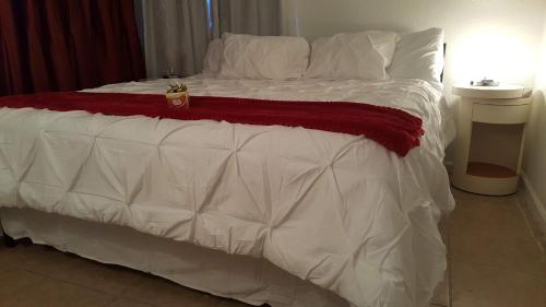 a large bed with white sheets and pillows at Dream King Bed-2BD-12 min to Strip in Las Vegas