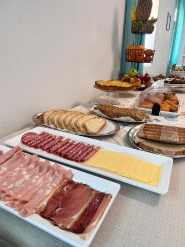 a table with different types of meats and cheese at Hotel Valente in Ortona
