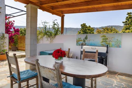 - une table avec un vase de fleurs sur la terrasse dans l'établissement Eliva house, à La Canée